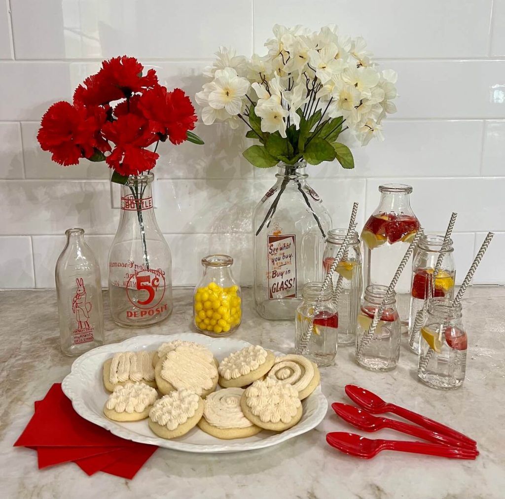 antique glass milk bottles used as pitchers and drinking glasses