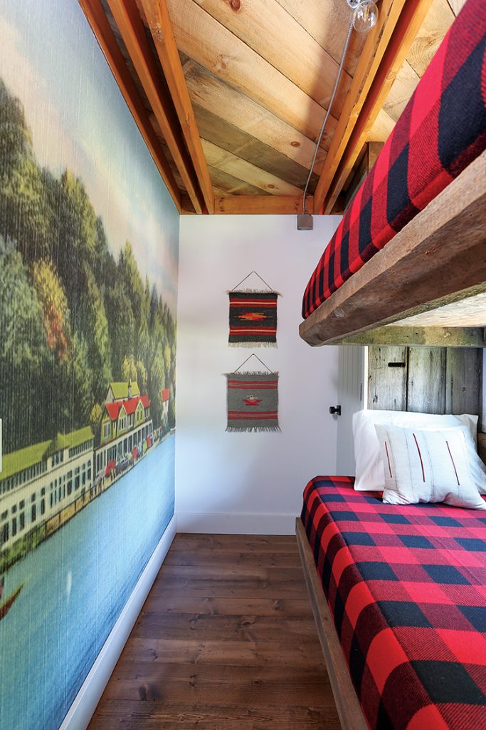 bunk beds with buffalo plaid bedding and scenic wall art