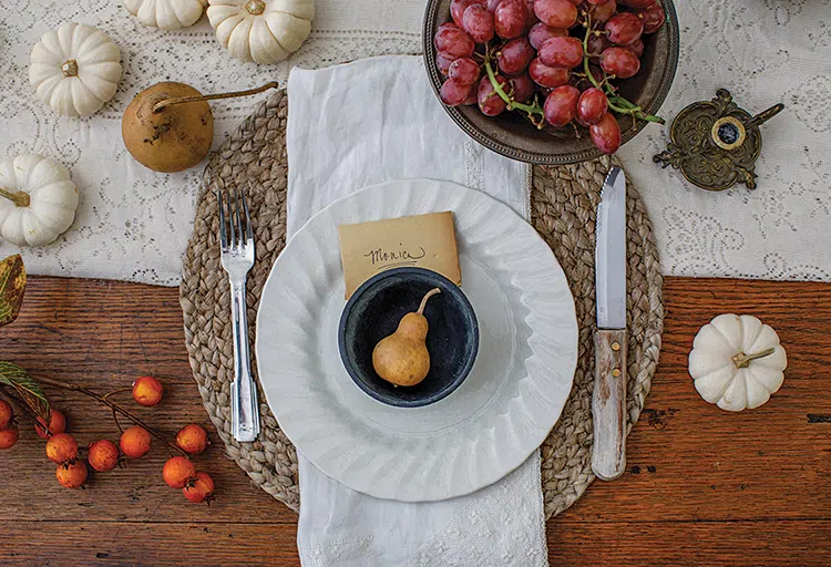 place setting with woven charger and pear and white pumpkins as decor in Florida home decorated for fall