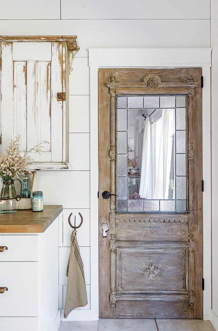 vintage wooden door with carved detail and window