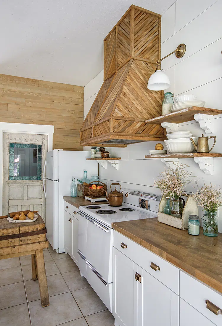 exposed wood shelves supported by corbels in white and wood kitchen