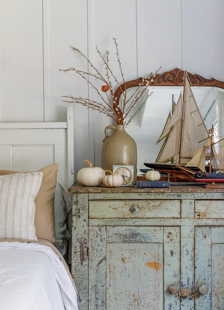 vintage sailboat figures and white pumpkins in Florida home bedroom