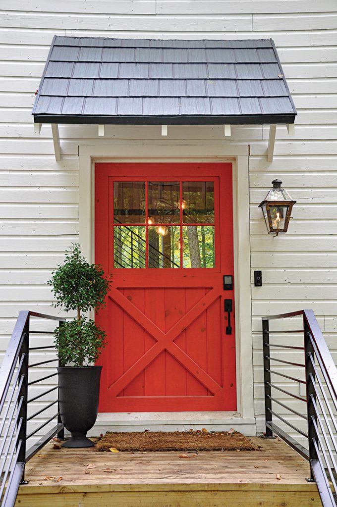 red door of renovated old barn with smart doorbell