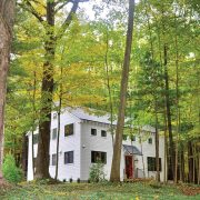 exterior view of renovated old barn home surrounded by western Michigan trees