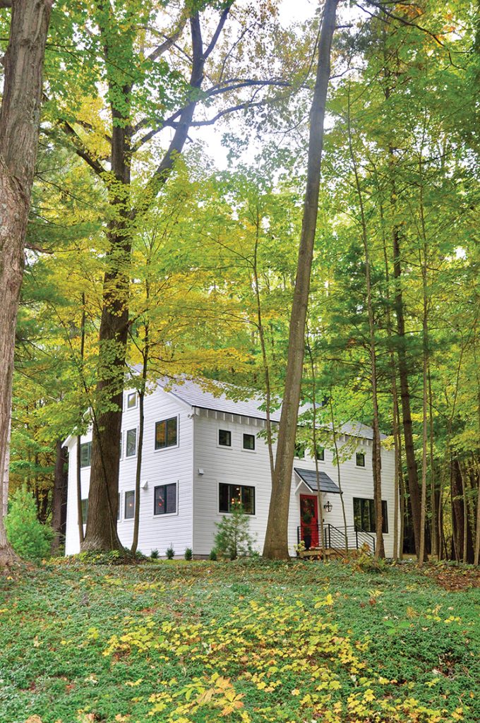 exterior view of renovated old barn home surrounded by western Michigan trees