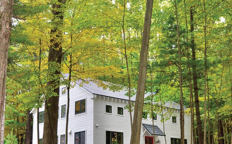 exterior view of renovated old barn home surrounded by western Michigan trees