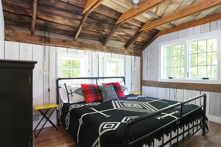 bedroom in renovated barn home with modern lighting