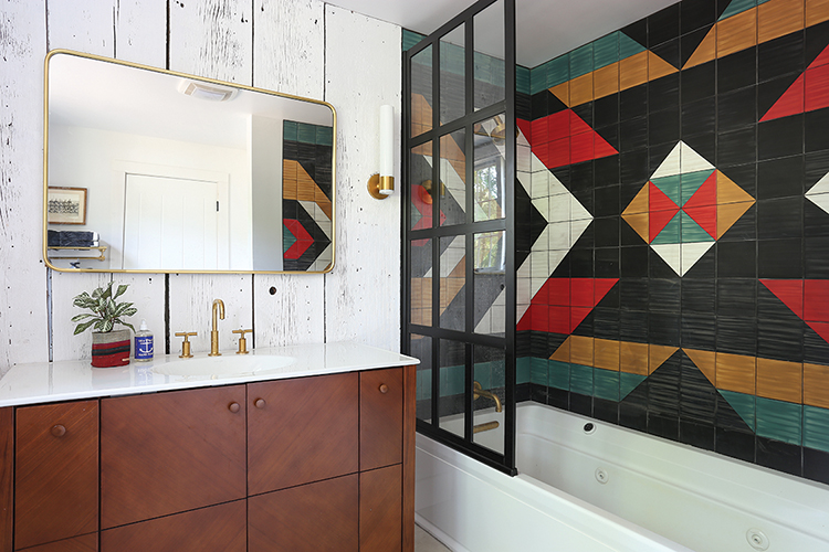 tile in Southwestern pattern and tub with jets in renovated barn home