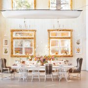 farmhouse cabin in Big Bear features flowers wooden window frames and chandeliers hanging from old canoe