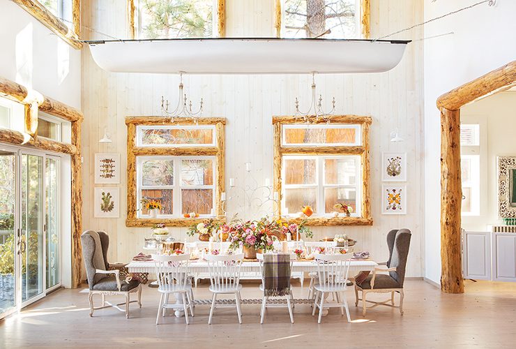 farmhouse cabin in Big Bear features flowers wooden window frames and chandeliers hanging from old canoe