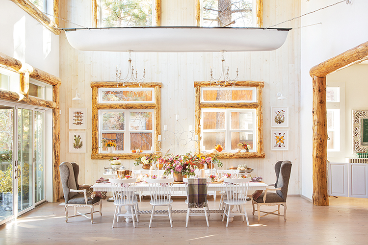 farmhouse cabin in Big Bear features flowers wooden window frames and chandeliers hanging from old canoe