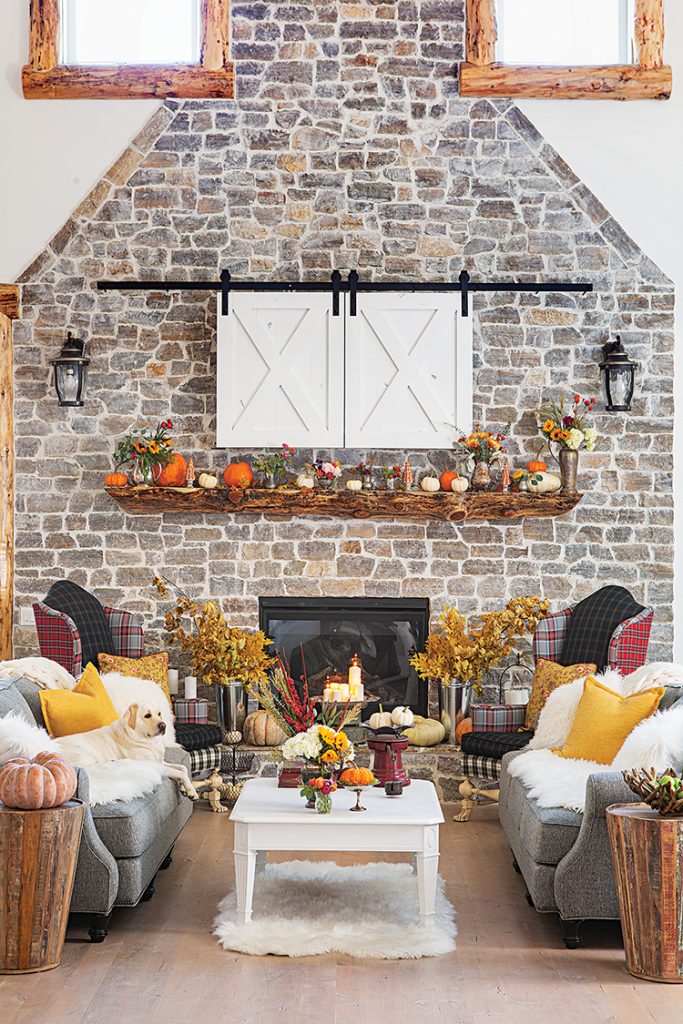 mantel decorated with fall floral arrangements and pumpkins in spacious Big Bear cabin