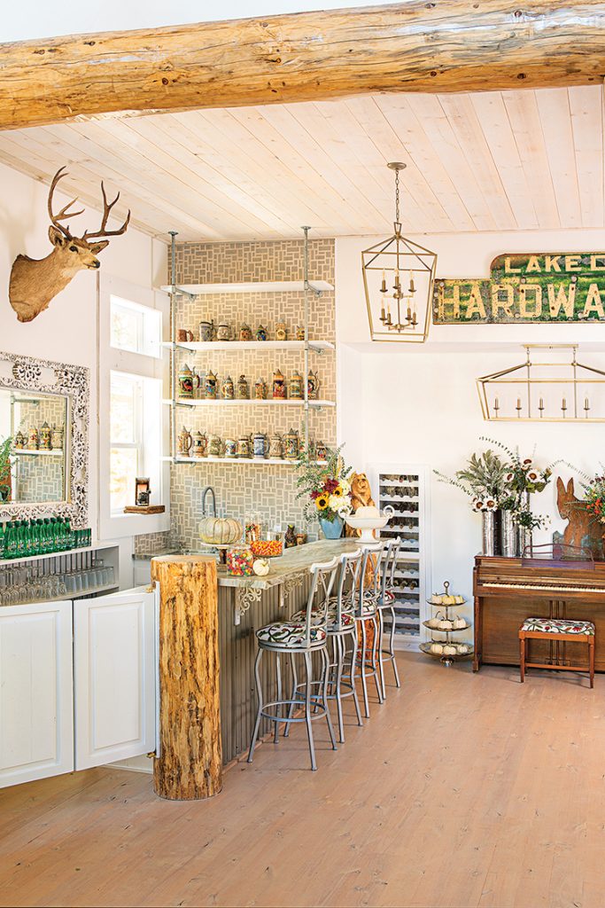 counter seating and old piano and vintage sign decorate Big Bear farmhouse cabin