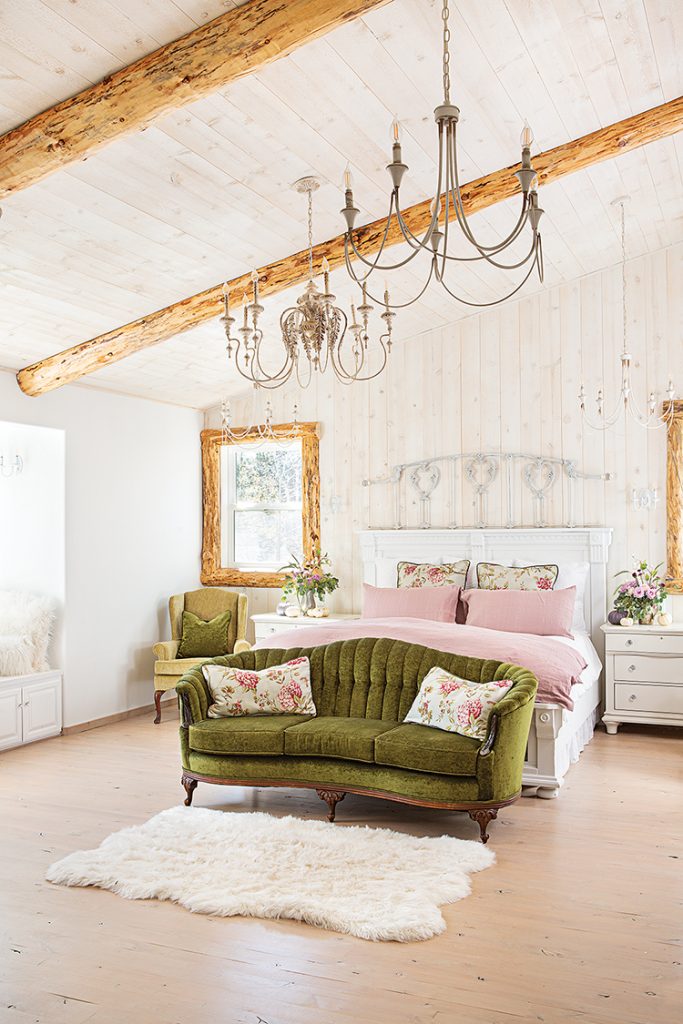 spacious bedroom with pink and green furniture, vaulted ceilings and white bedframe