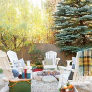 vintage thermoses in outdoor fire ring with wooden chairs