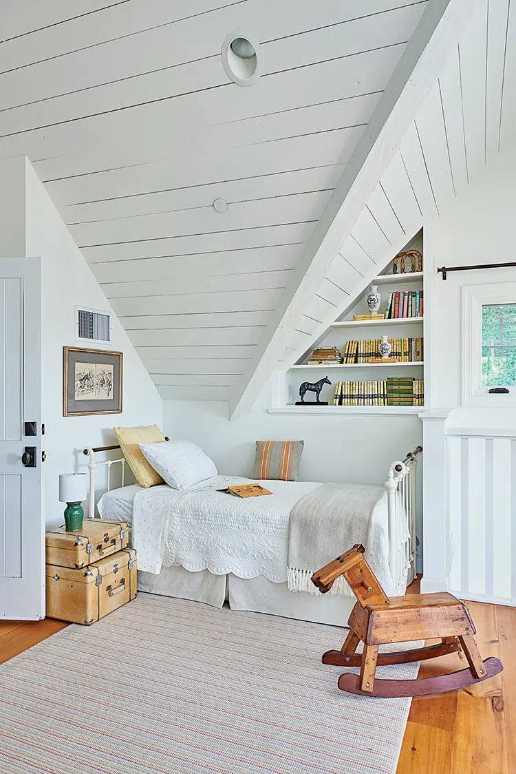 collection of vintage books in built-in shelves of guest room