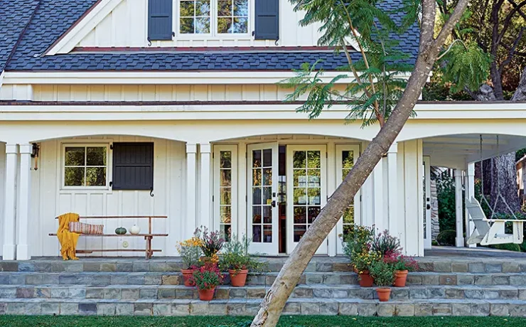 exterior of authentic farmhouse in Ojai with white siding and dark blue shutters