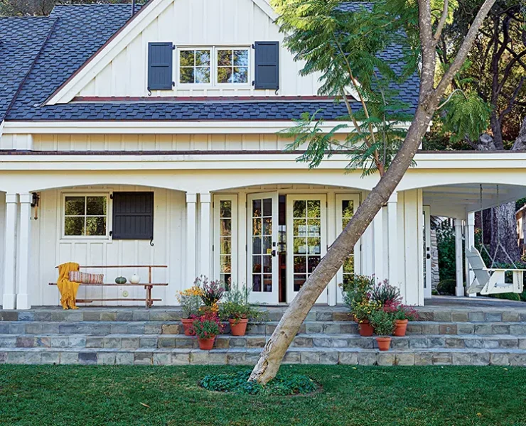 exterior of authentic farmhouse in Ojai with white siding and dark blue shutters