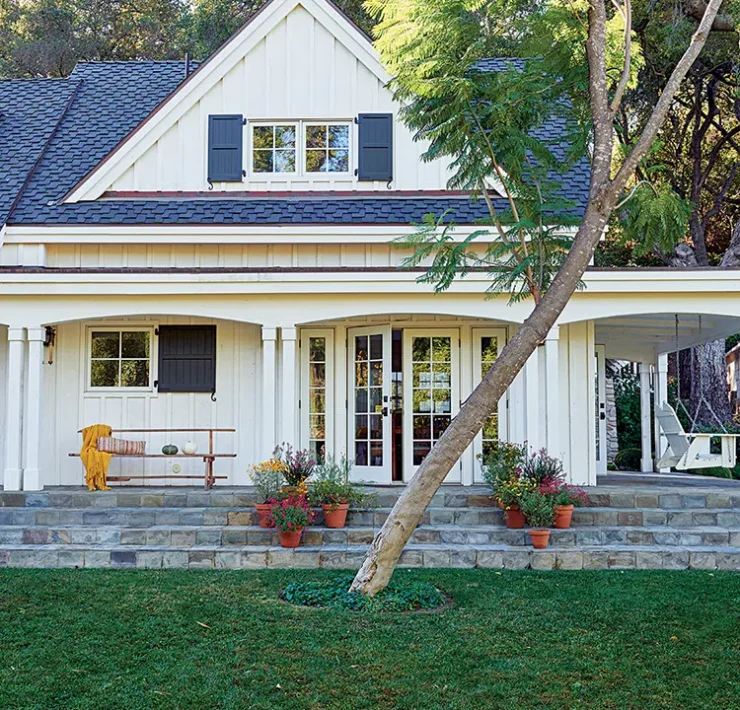 exterior of authentic farmhouse in Ojai with white siding and dark blue shutters