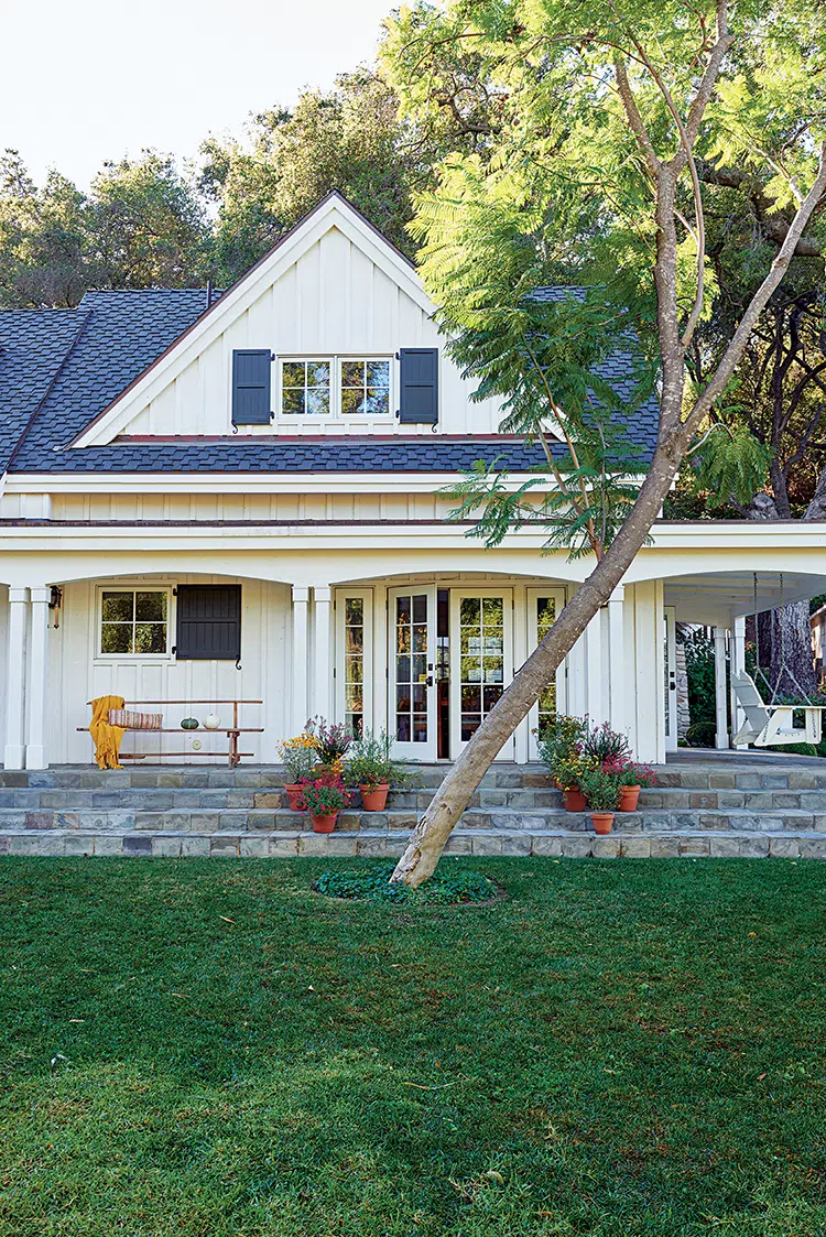 exterior of authentic farmhouse in Ojai with white siding and dark blue shutters