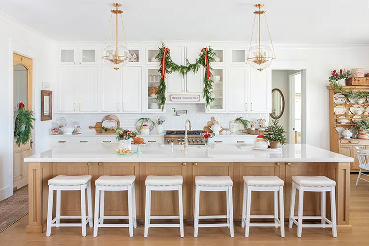 home with vintage kitchenalia at Christmastime with natural garland on high cabinet