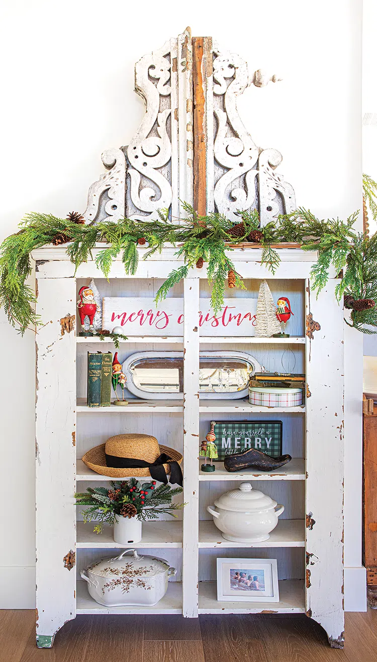 vintage ironstone and cornices and Christmas figurines in white chest with natural cedar garland