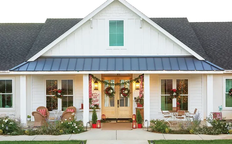 exterior of vintage home at Christmastime with wreaths on the doors and windows