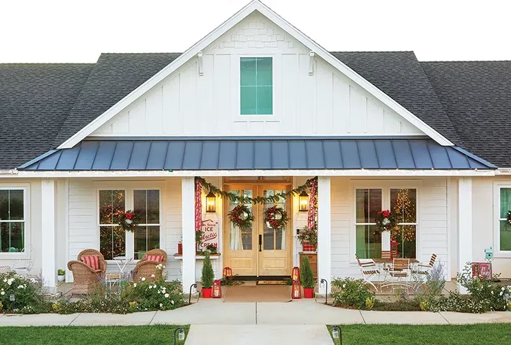 exterior of vintage home at Christmastime with wreaths on the doors and windows