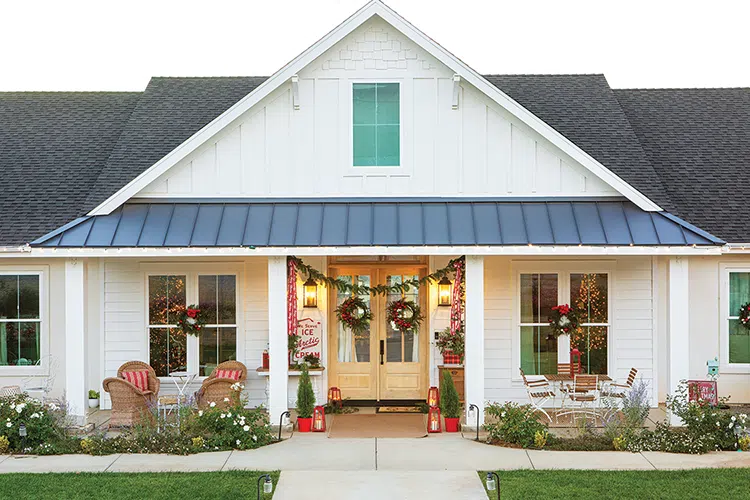 exterior of vintage home at Christmastime with wreaths on the doors and windows