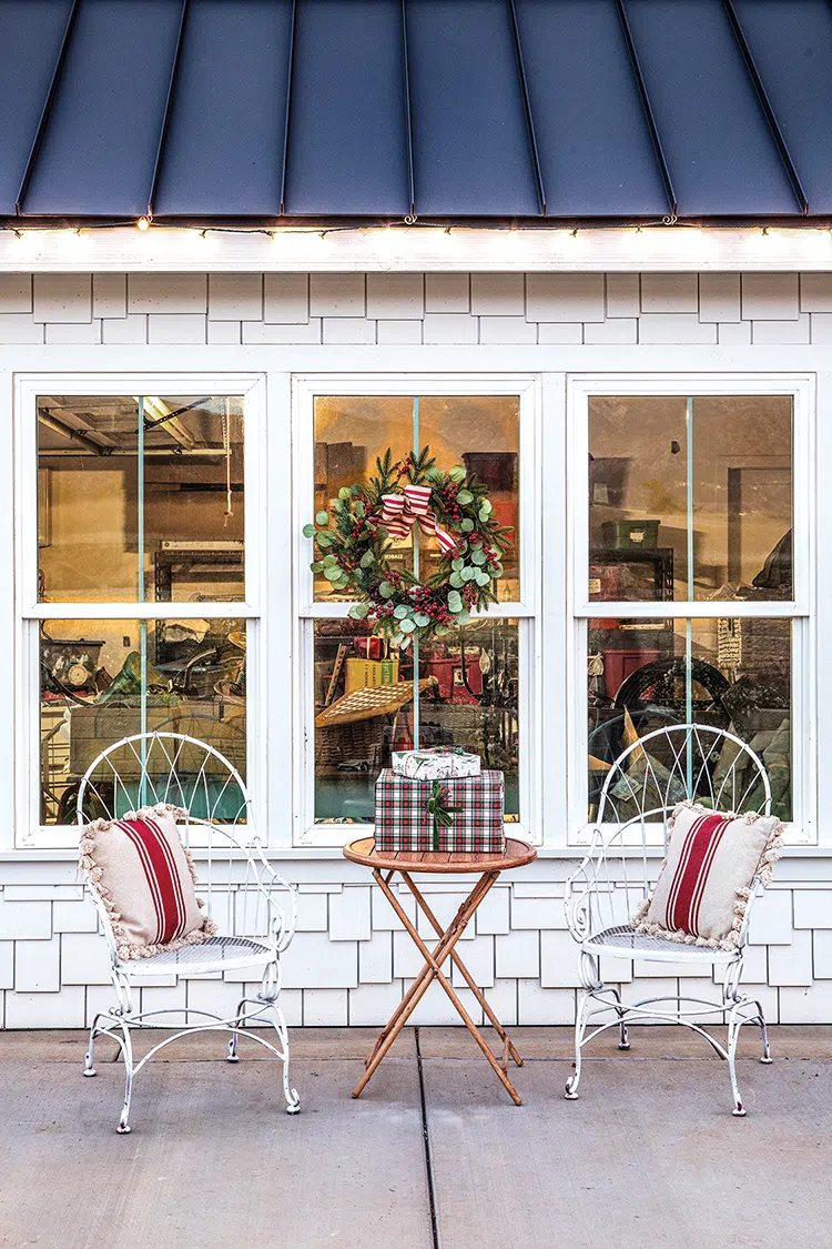 outdoor sitting area of vintage home decorated for Christmas