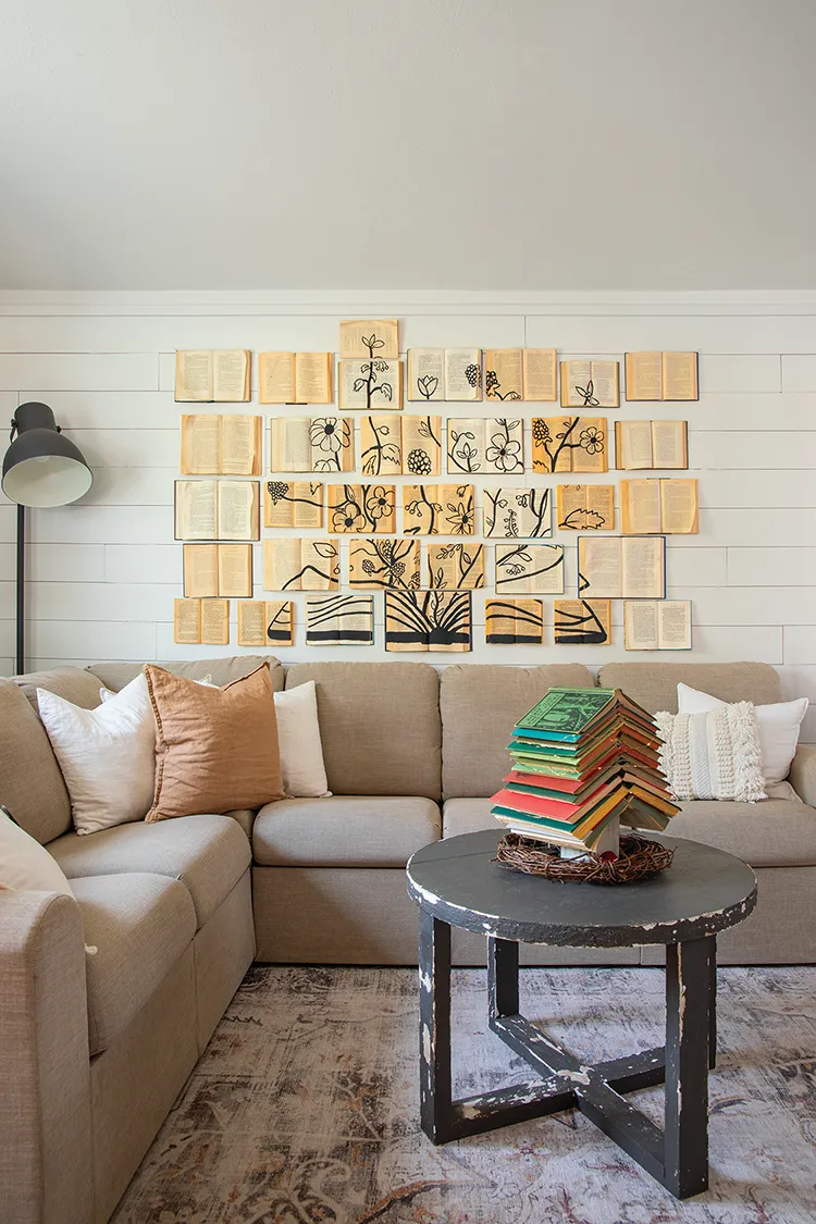 vintage book art as decor in neutral living room decorated for Christmas