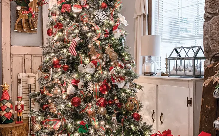 Christmas tree with red and white presents underneath and basket of red poinsettias