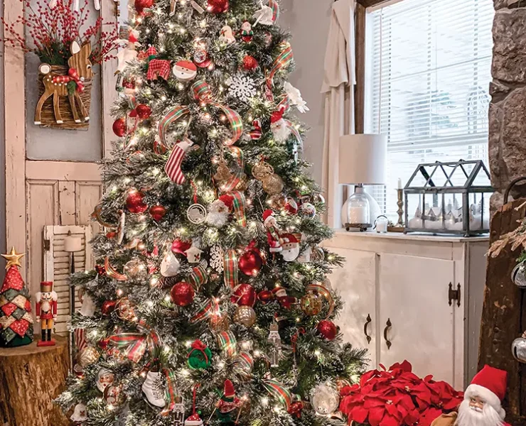 Christmas tree with red and white presents underneath and basket of red poinsettias