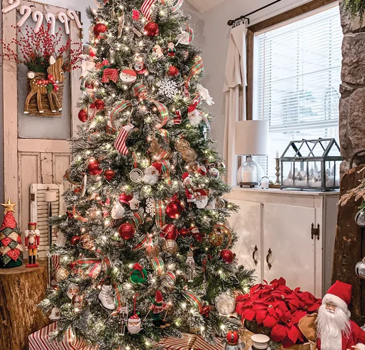 Christmas tree with red and white presents underneath and basket of red poinsettias