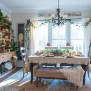 winter tablescape with beige and cream tablecloth and layered place settings