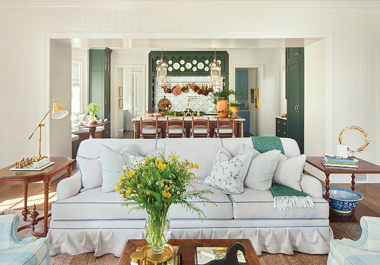 green cabinetry in kitchen visible from living room in Project House Utah