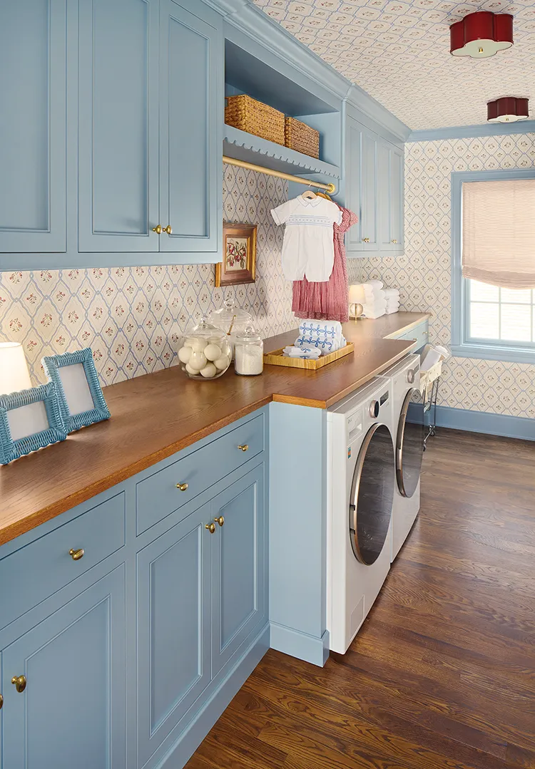 laundry room with powder blue cabintery