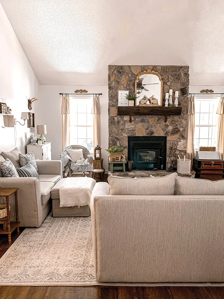 living room with stone fireplace