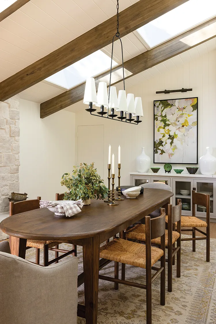 dining room with long chandelier and abstract floral painting on the wall