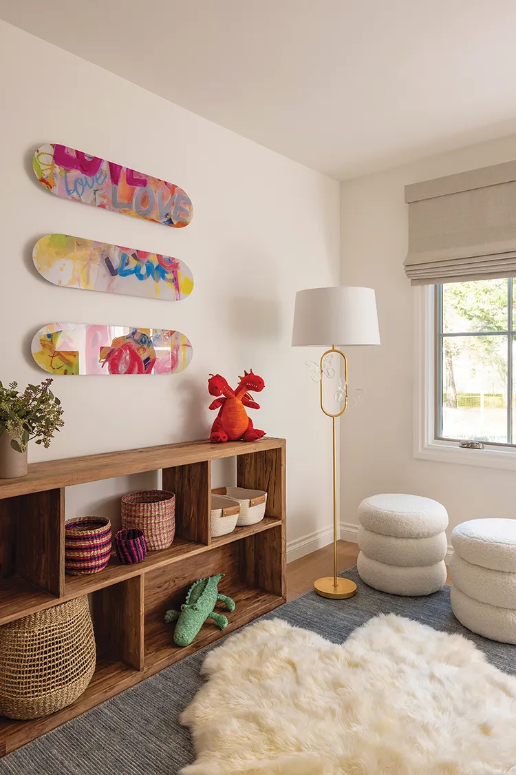 shelves in kids room with baskets and skateboard art above