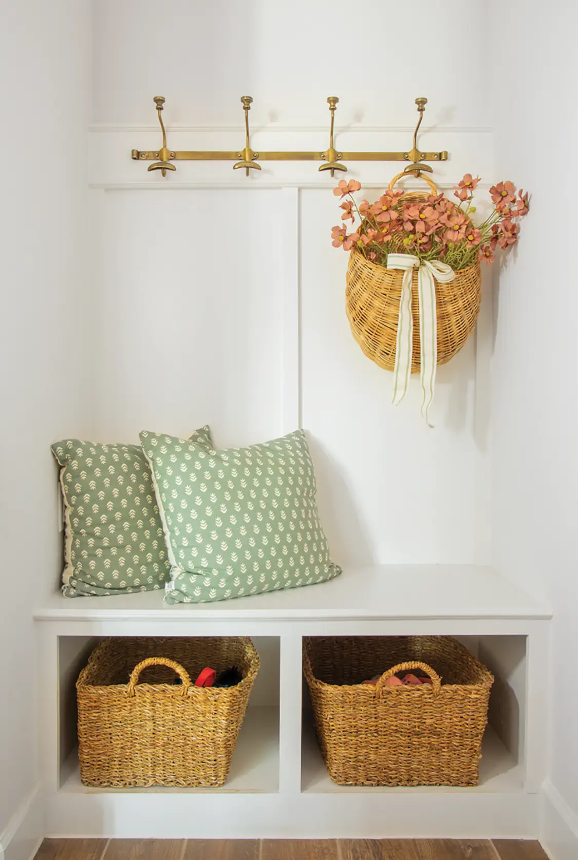 woven basket hanging in mudroom with peach pink flowers