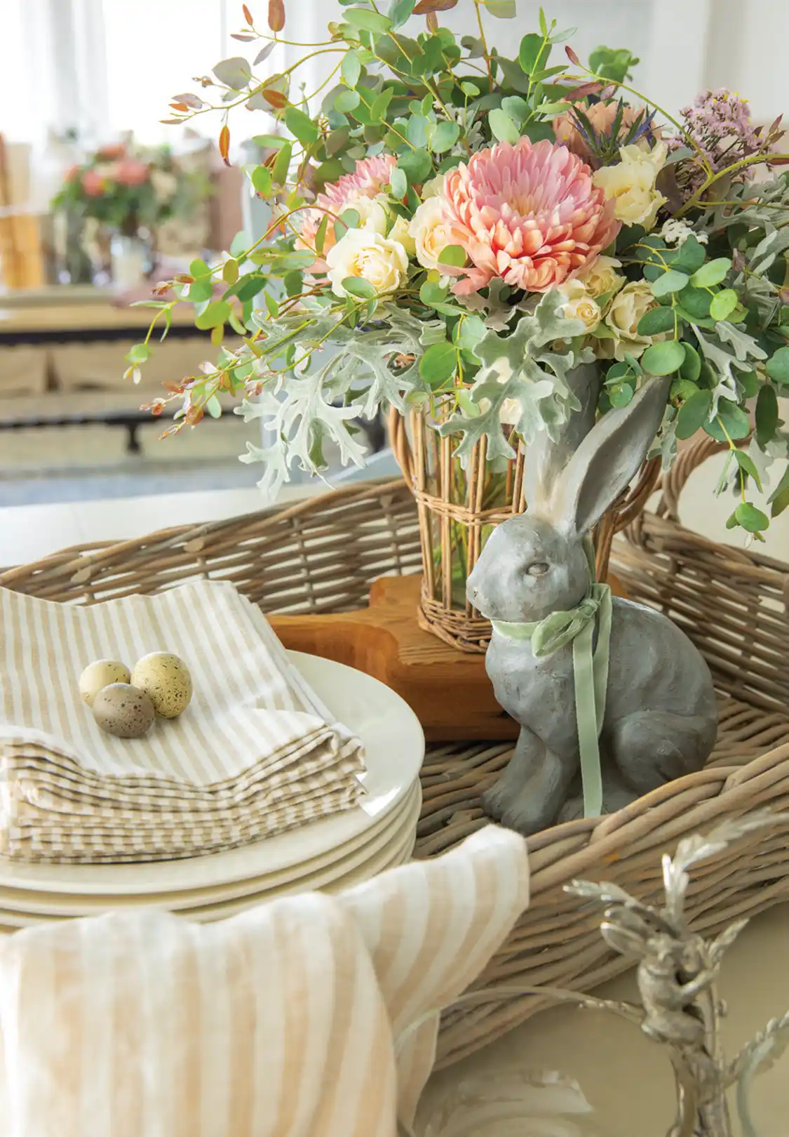 spring vignette in wove tray with flowers, bunny sculpture and miniature eggs