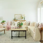 living room with potted plants floral bouquets and vintage furniture pieces