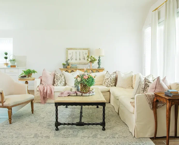 living room with potted plants floral bouquets and vintage furniture pieces