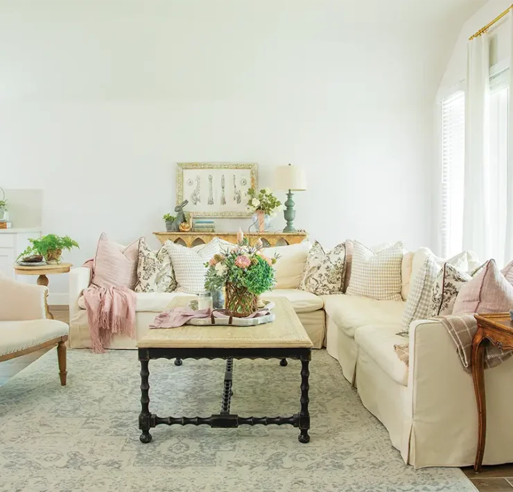 living room with potted plants floral bouquets and vintage furniture pieces