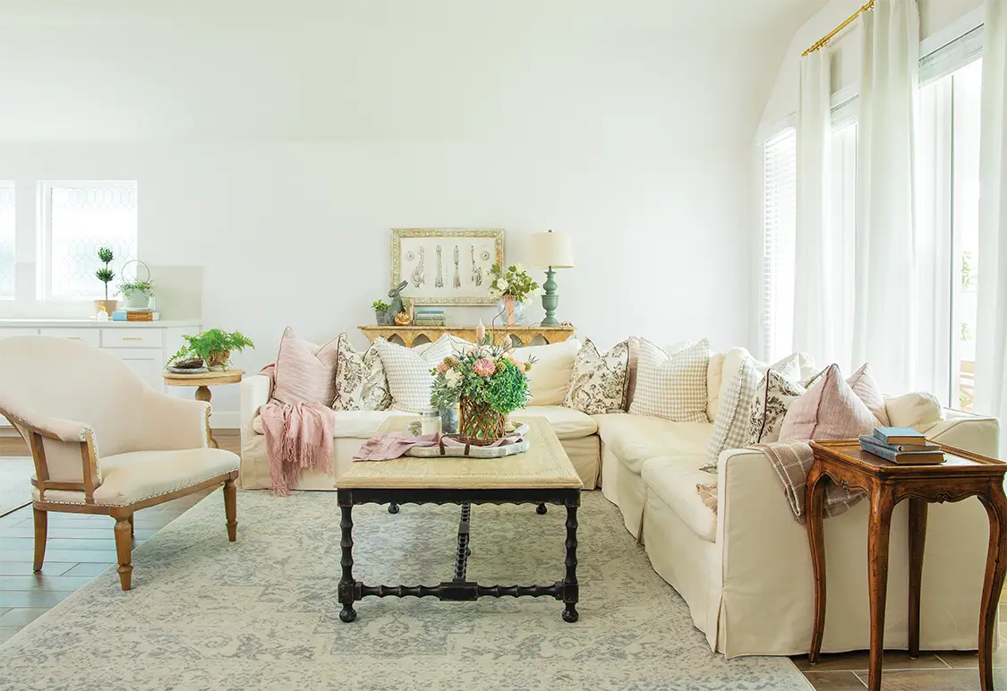 living room with potted plants floral bouquets and vintage furniture pieces