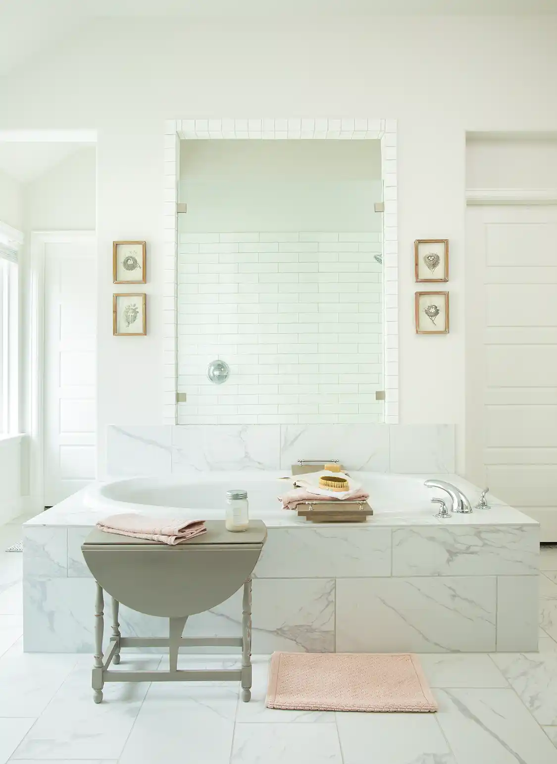 all white bathroom with black and white framed prints of birds' nests