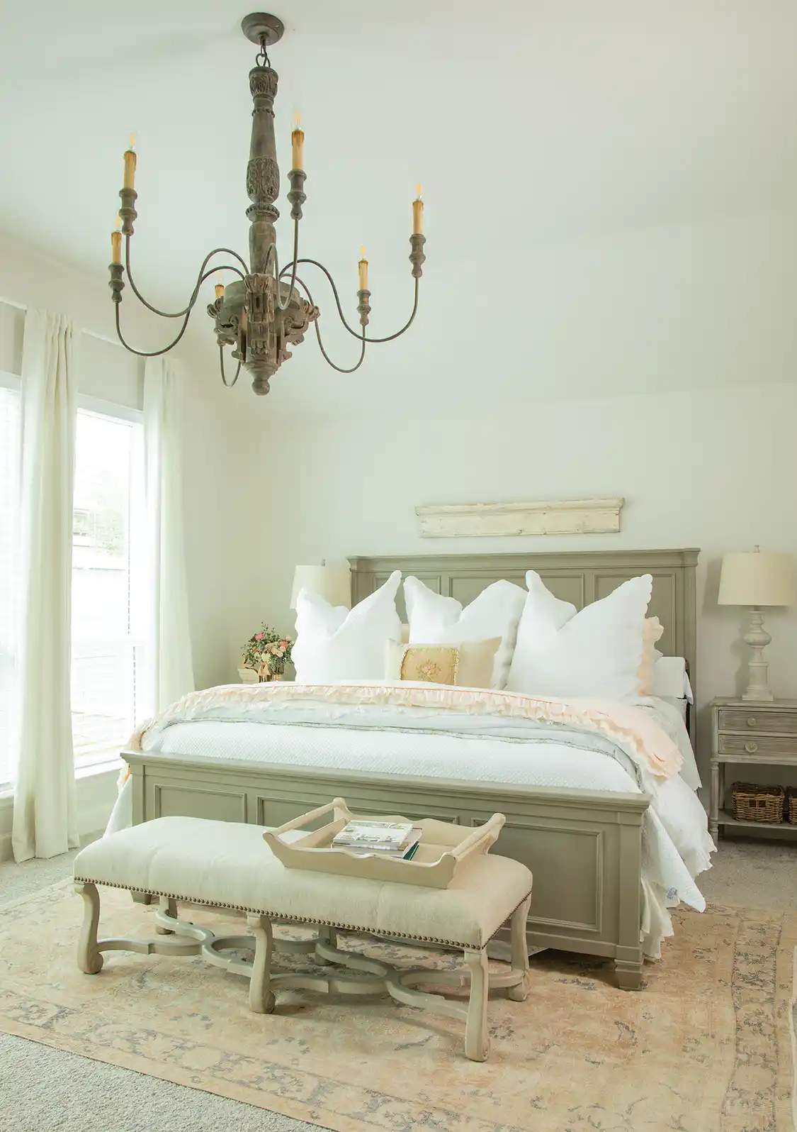 moss green bedframe in new build farm cottage with Franch country chandelier