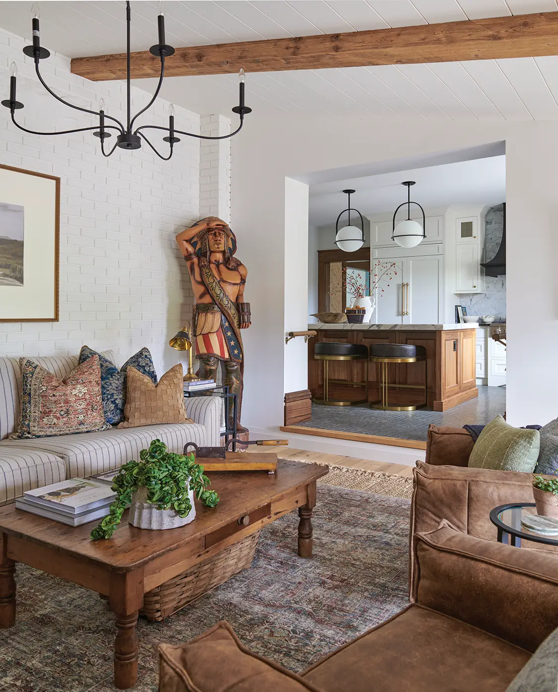 living room with white painted brick and black farmhouse chandelier