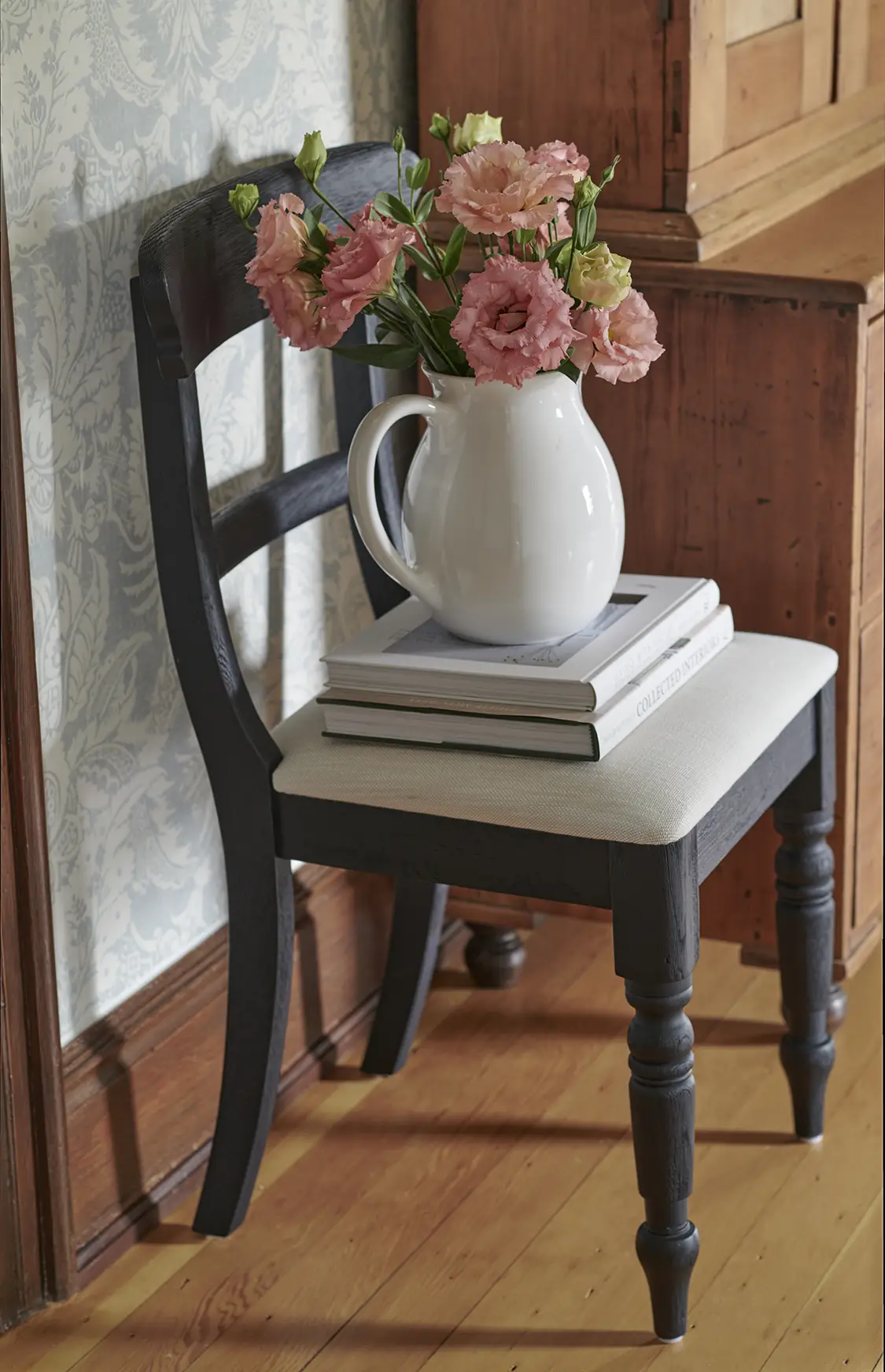 white pitcher used as flower vase